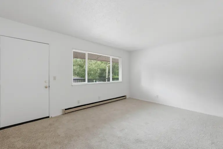 Living room with front door and window